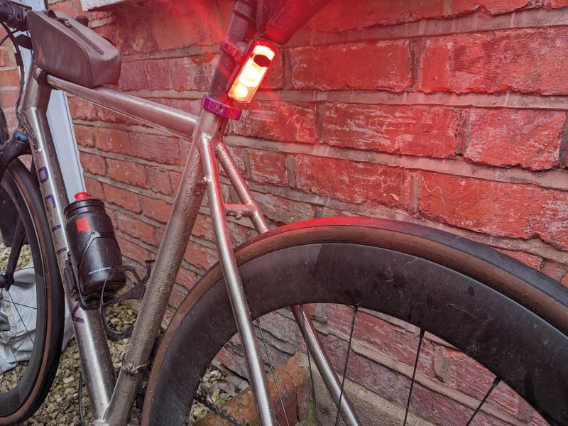 See.Sense ICON3 rear light attached to a bike seat pole with the light shining red